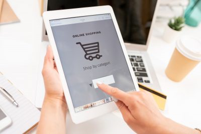 Hand of young mobile shopper pointing at search line on touchscreen