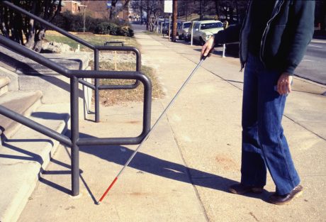 Image of a visually impaired person using a walking stick